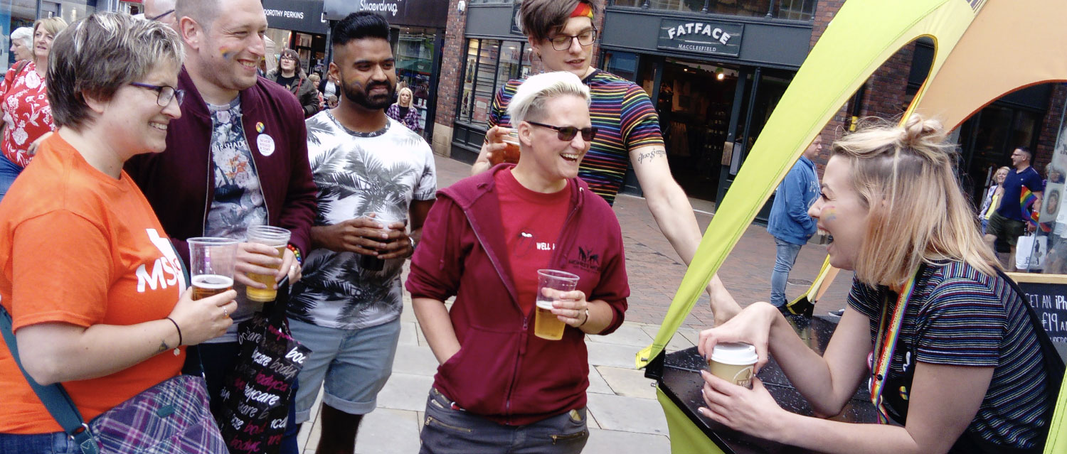 A group of people talking outside with the Body Positive team