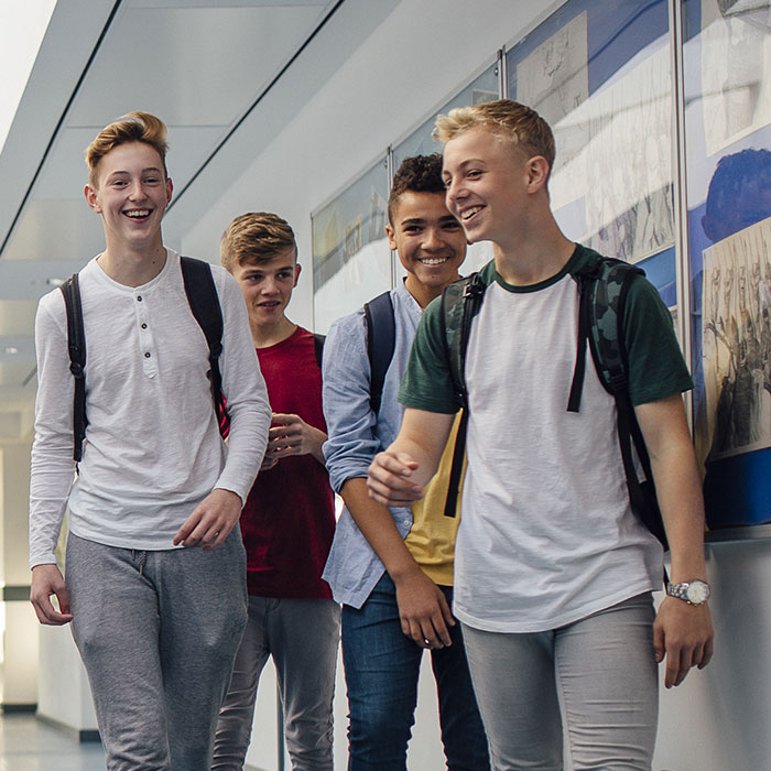 A group of young adults walking in a corridor